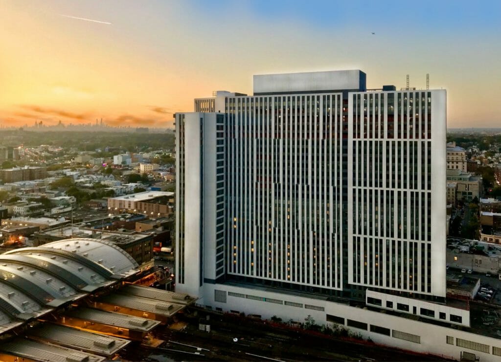 Crossing at Jamaica Station 4 The Crossing and NYC skyline at night 1024x740 New York Housing Conference